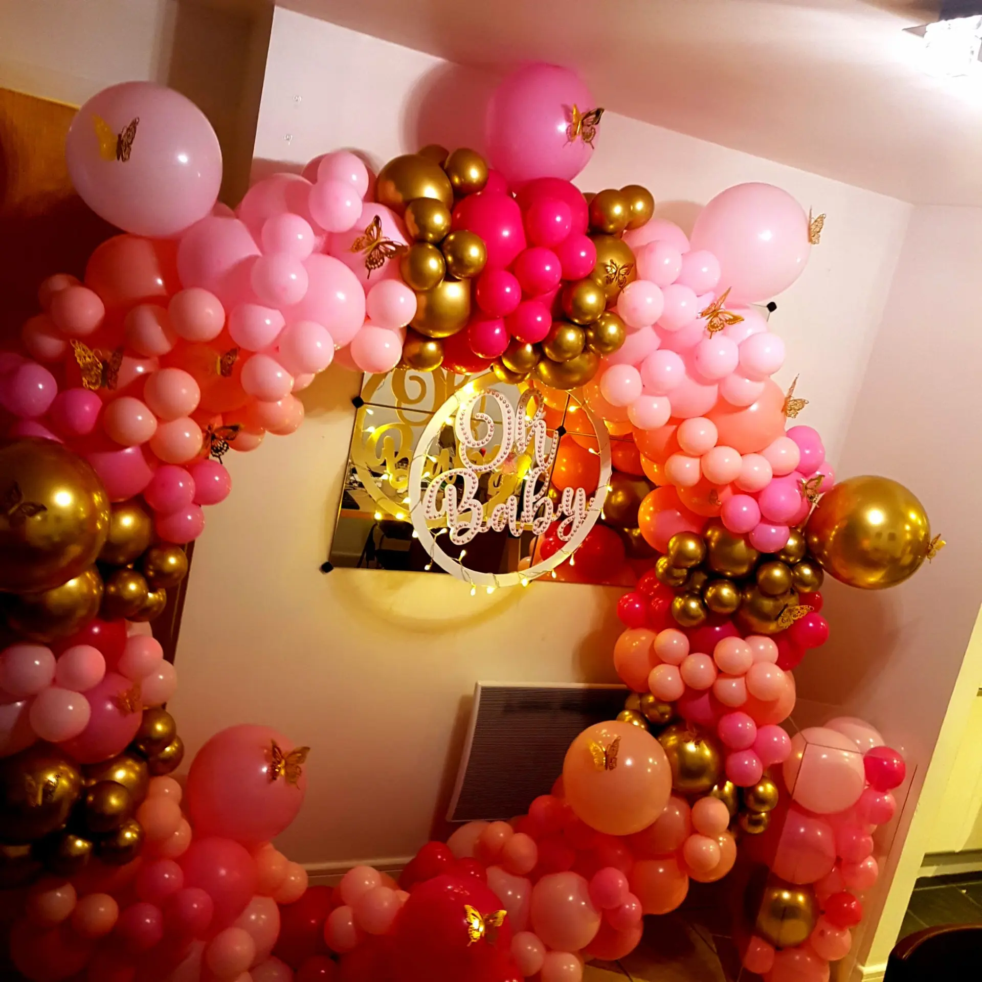 Pink, blush and gold balloon hoop with a baby celebration sign